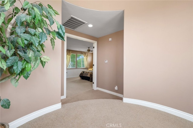 hall featuring recessed lighting, visible vents, carpet flooring, and baseboards