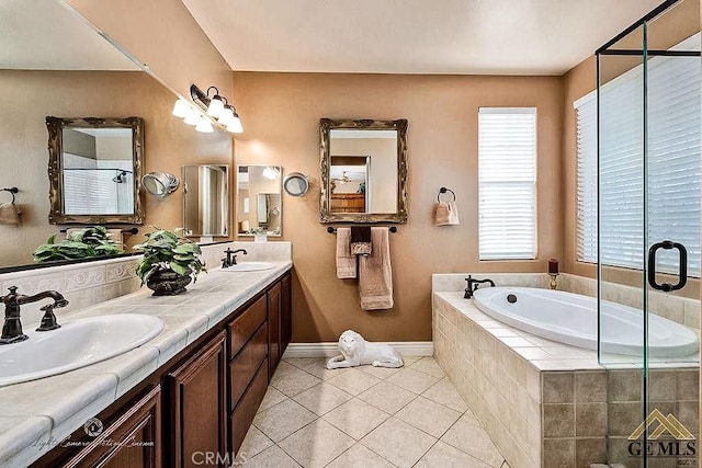 5206 Village Green Ln, Bakersfield, CA 93306 - full bath featuring a bath, tile patterned flooring, double vanity, a shower stall, and baseboards
