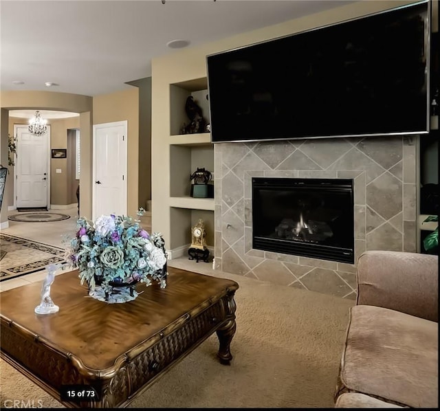 5206 Village Green Ln, Bakersfield, CA 93306 - living area with built in shelves, baseboards, a tile fireplace, and a chandelier