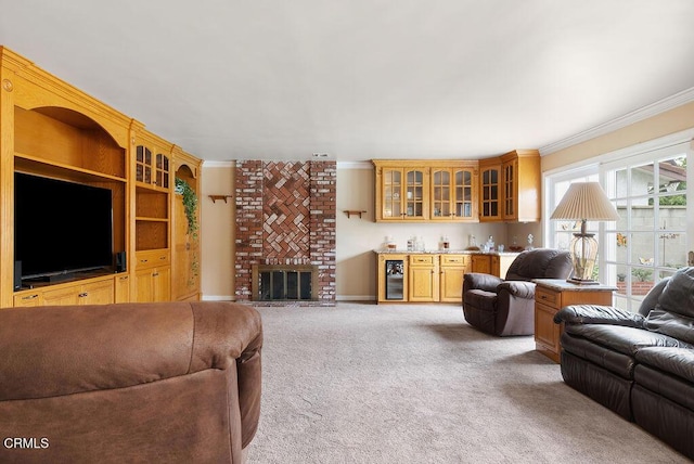 living area with indoor wet bar, ornamental molding, a fireplace, and light carpet