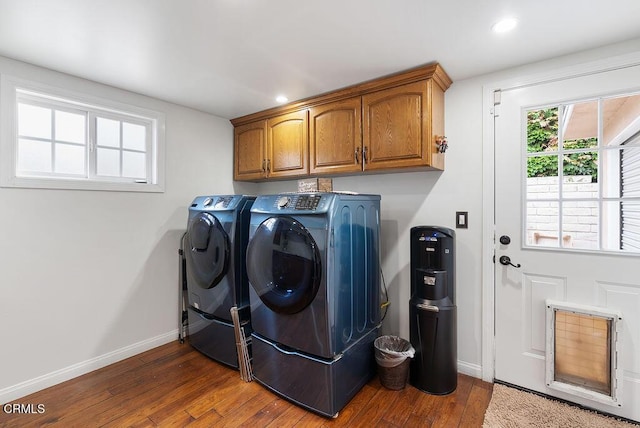 laundry area featuring washing machine and dryer, baseboards, dark wood-style floors, recessed lighting, and cabinet space