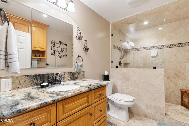 bathroom with visible vents, walk in shower, vanity, tile patterned floors, and toilet