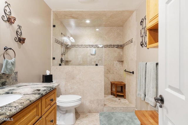 full bath featuring toilet, walk in shower, tile patterned flooring, and vanity