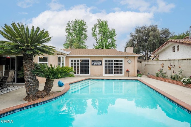 view of pool with a fenced in pool, fence, and a patio