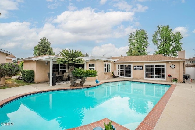 outdoor pool with a patio area