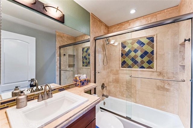 bathroom with combined bath / shower with glass door, vanity, and toilet