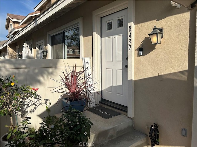 property entrance with stucco siding