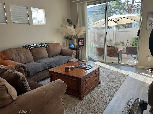 living area with plenty of natural light and wood finished floors