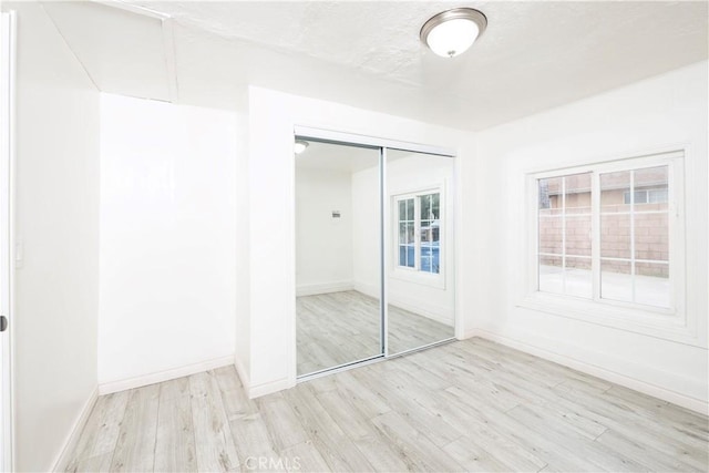 1181 W 4th St, Pomona, CA 91766 - unfurnished bedroom featuring wood finished floors, a closet, and baseboards