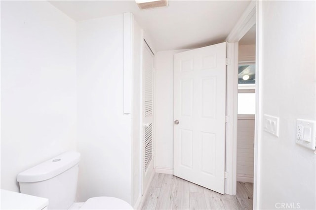1181 W 4th St, Pomona, CA 91766 - bathroom featuring wood finished floors, toilet, and baseboards