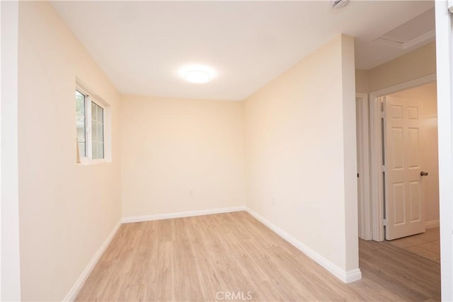 1181 W 4th St, Pomona, CA 91766 - unfurnished room featuring light wood-type flooring, attic access, and baseboards