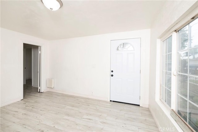 1181 W 4th St, Pomona, CA 91766 - unfurnished room with baseboards, radiator heating unit, and light wood-style flooring