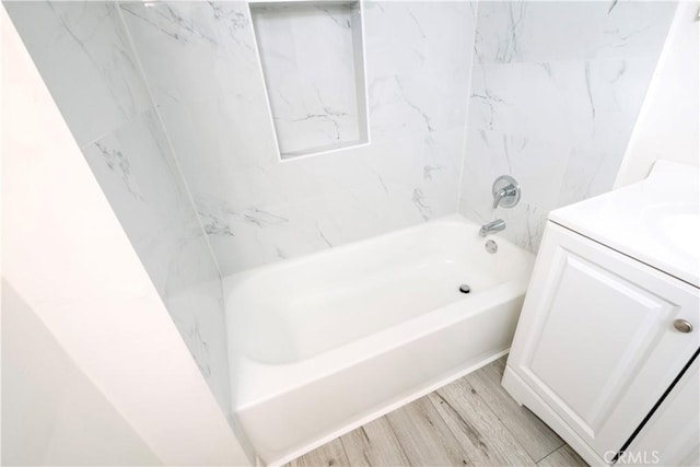 1181 W 4th St, Pomona, CA 91766 - full bathroom featuring wood finished floors, vanity, and tub / shower combination