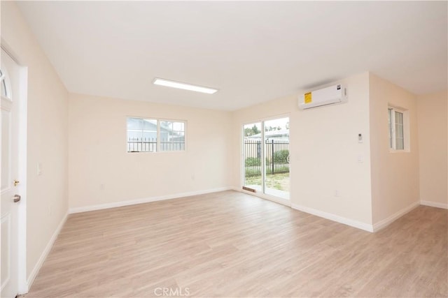 1181 W 4th St, Pomona, CA 91766 - empty room featuring light wood finished floors, baseboards, and a wall mounted AC