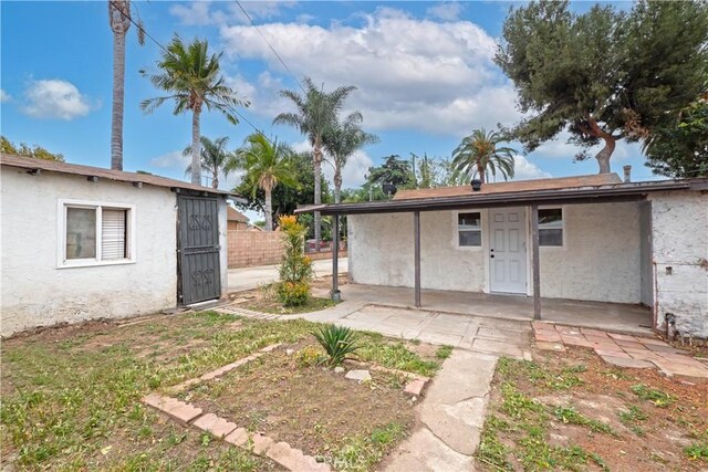 1181 W 4th St, Pomona, CA 91766 - rear view of property with stucco siding, fence, and a patio area