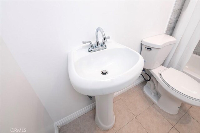 1181 W 4th St, Pomona, CA 91766 - full bath featuring baseboards, tile patterned flooring, and toilet