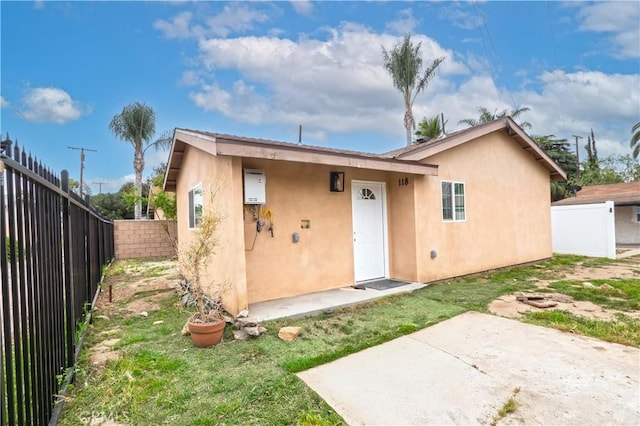 1181 W 4th St, Pomona, CA 91766 - rear view of property featuring a patio, a fenced backyard, and stucco siding