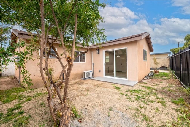 1181 W 4th St, Pomona, CA 91766 - rear view of house featuring stucco siding, fence, and ac unit