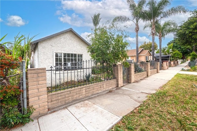 1181 W 4th St, Pomona, CA 91766 - view of front of house featuring stucco siding and a fenced front yard