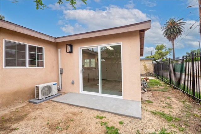 1181 W 4th St, Pomona, CA 91766 - rear view of property with ac unit, stucco siding, and fence