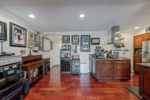 indoor dry bar featuring wall chimney exhaust hood, crown molding, stainless steel fridge, dark wood-style floors, and recessed lighting