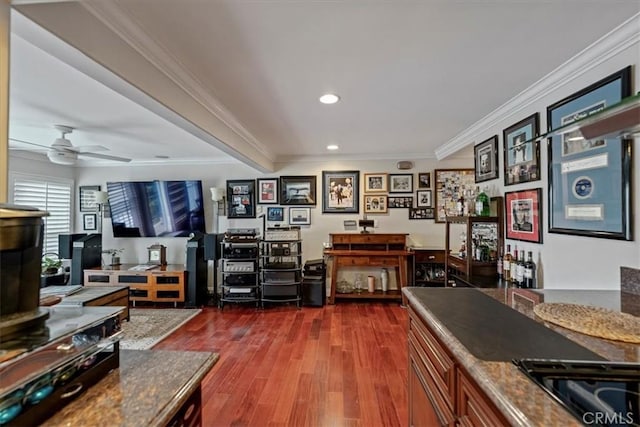interior space featuring crown molding, dark wood-type flooring, a ceiling fan, recessed lighting, and black stovetop