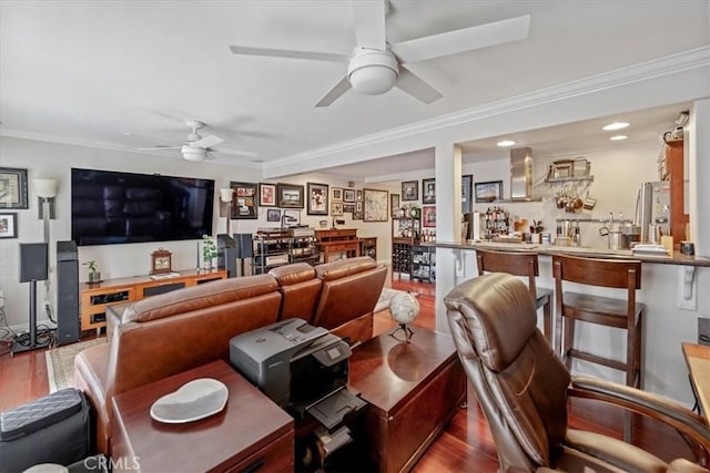 living area with a ceiling fan, ornamental molding, wood finished floors, and recessed lighting