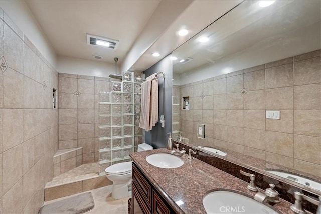bathroom featuring walk in shower, toilet, and double vanity