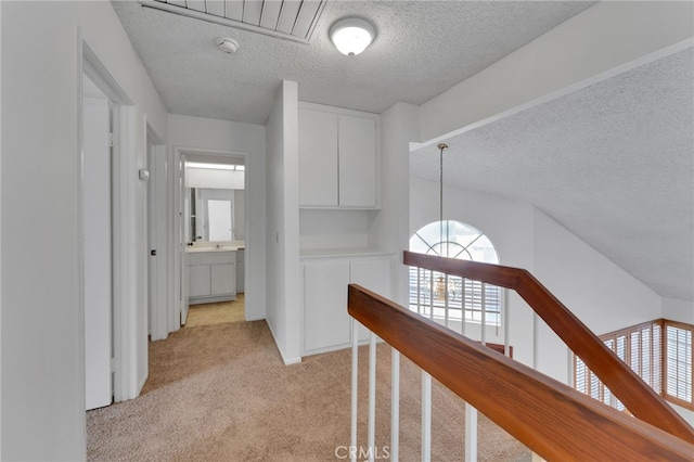 2766 Rippling Brook Pl, Ontario, CA 91761 - corridor featuring a textured ceiling, light colored carpet, plenty of natural light, an upstairs landing, and a chandelier