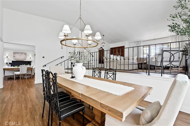dining area with wood finished floors and a notable chandelier
