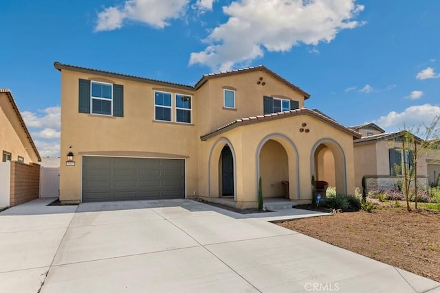 5085 Hoss Cir, Hemet, CA 92545 - mediterranean / spanish home featuring a garage, stucco siding, driveway, and a tiled roof