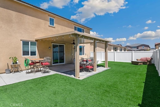 5085 Hoss Cir, Hemet, CA 92545 - rear view of house featuring stucco siding, a fenced backyard, a patio area, and ceiling fan