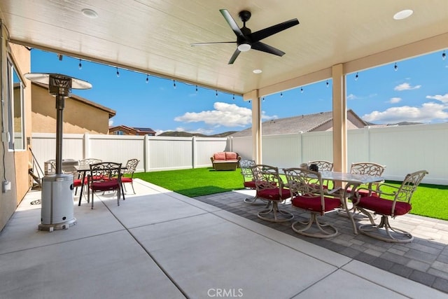 5085 Hoss Cir, Hemet, CA 92545 - fenced backyard featuring outdoor dining area, a patio, and a ceiling fan