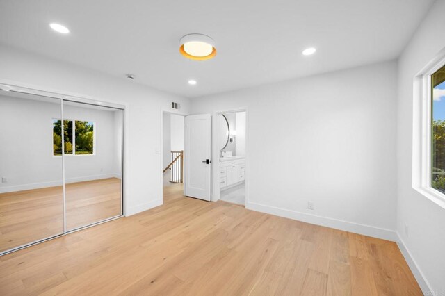 930 N Holly Glen Dr, Long Beach, CA 90815 - unfurnished bedroom with recessed lighting, light wood-type flooring, a closet, and baseboards