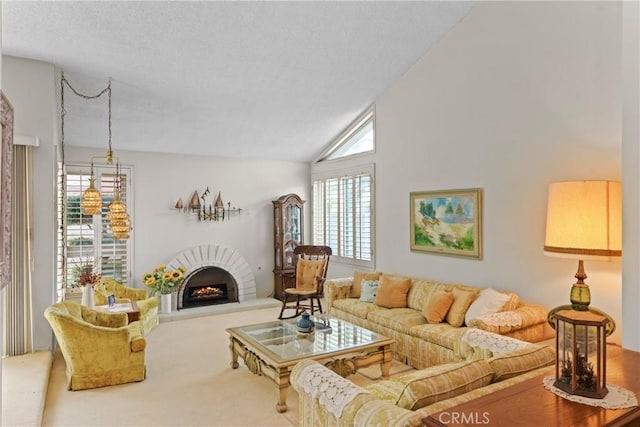 living room featuring a fireplace, carpet floors, a textured ceiling, and high vaulted ceiling