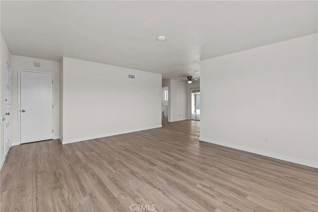 603 S Palm Ave Unit A, Hemet, CA 92543 - unfurnished living room featuring visible vents, a ceiling fan, light wood-style flooring, and baseboards