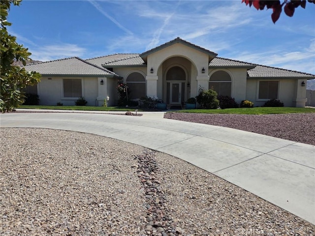 16635 Century Plant Rd, Apple Valley, CA 92307 - mediterranean / spanish-style home featuring stucco siding, a tile roof, and curved driveway