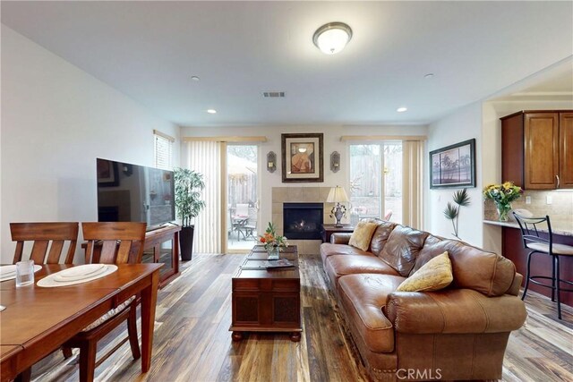 117 Village Cir, Pismo Beach, CA 93449 - living area with a tiled fireplace, wood finished floors, visible vents, and a wealth of natural light