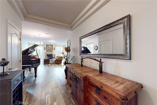 117 Village Cir, Pismo Beach, CA 93449 - hall featuring visible vents, a notable chandelier, a tray ceiling, and hardwood / wood-style flooring