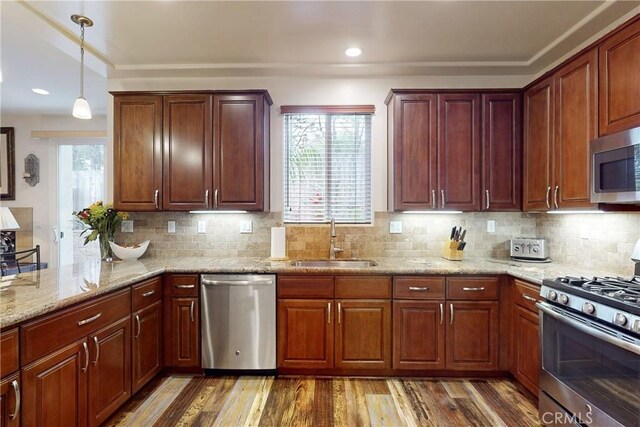 117 Village Cir, Pismo Beach, CA 93449 - kitchen featuring plenty of natural light, appliances with stainless steel finishes, wood finished floors, a sink, and light stone counters