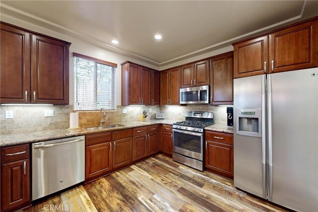 117 Village Cir, Pismo Beach, CA 93449 - kitchen featuring stainless steel appliances, decorative backsplash, a sink, and wood finished floors