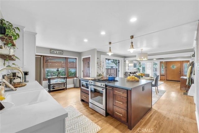 524 Walnut Ave, Long Beach, CA 90802 - kitchen with a center island, a sink, stainless steel range, light wood-style flooring, and recessed lighting