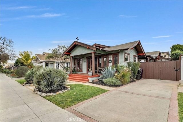 524 Walnut Ave, Long Beach, CA 90802 - bungalow featuring a gate, fence, driveway, and covered porch