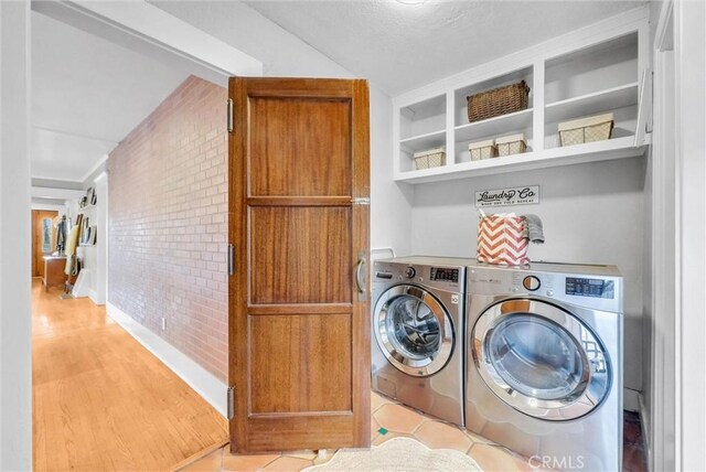 524 Walnut Ave, Long Beach, CA 90802 - washroom featuring brick wall and washer and clothes dryer