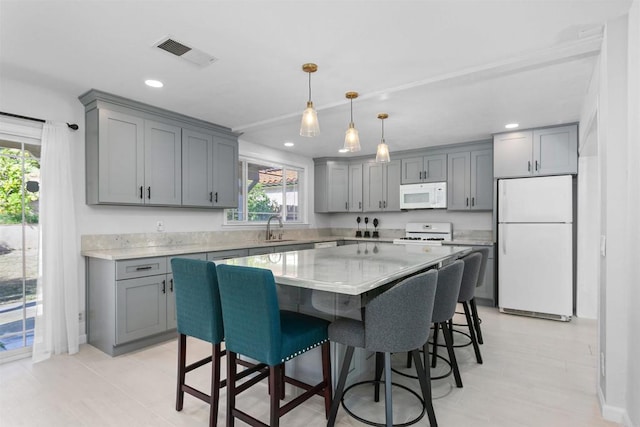10954 Cool Lake Ter, San Diego, CA 92128 - kitchen with visible vents, gray cabinets, a sink, and white appliances