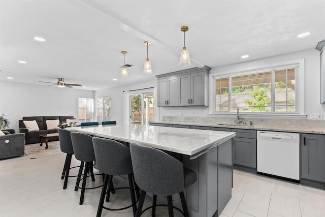 10954 Cool Lake Ter, San Diego, CA 92128 - kitchen featuring white dishwasher, gray cabinets, a breakfast bar area, and a sink