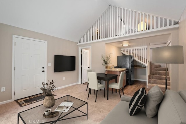 carpeted living room with high vaulted ceiling, baseboards, and stairway