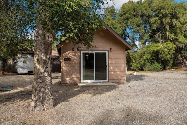 back of property with an outdoor structure