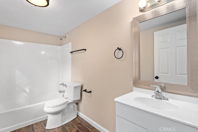bathroom with washtub / shower combination, wood tiled floor, toilet, vanity, and baseboards