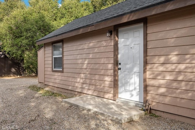view of outbuilding with an outbuilding and fence